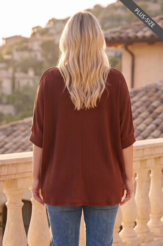 Back view of plus-size rust ribbed knit top with relaxed oversized fit
