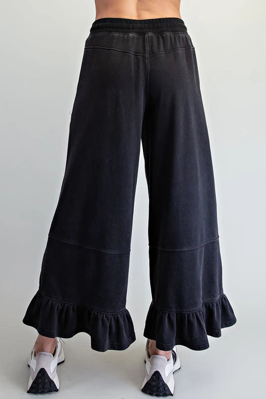 back view of ee:some ash black ruffle hem wide leg pants