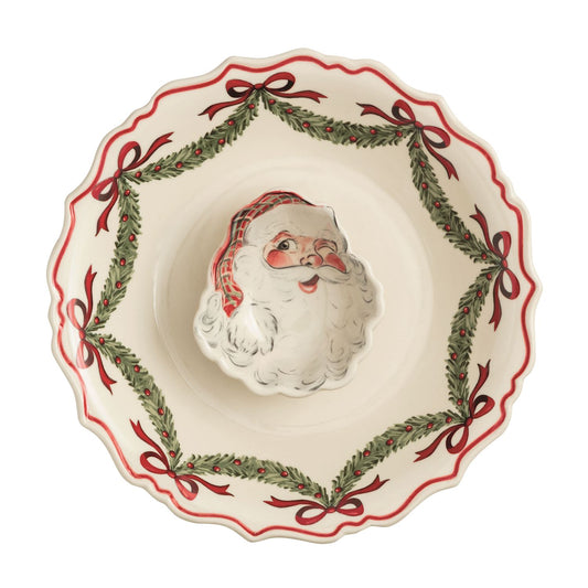 Mud Pie Santa Christmas chip and dip serving set styled with crackers on a festive red table with a green linen napkin.