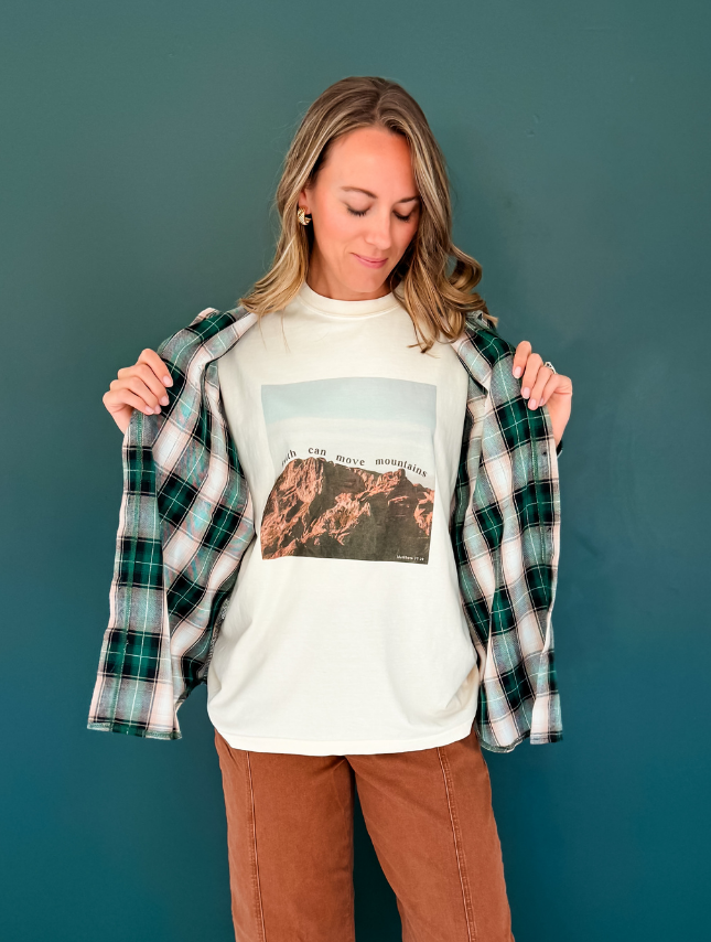 Woman styling Faith Can Move Mountains Christian Comfort Colors tee with plaid flannel