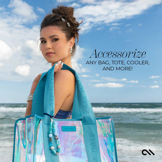 Blue turquoise beaded starfish bag charm attached to beach tote by the ocean