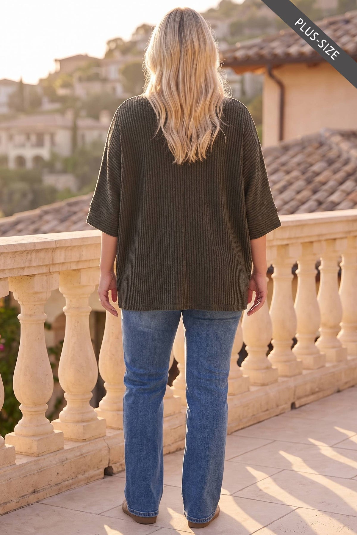 Back view of plus-size olive ribbed knit top with relaxed oversized fit