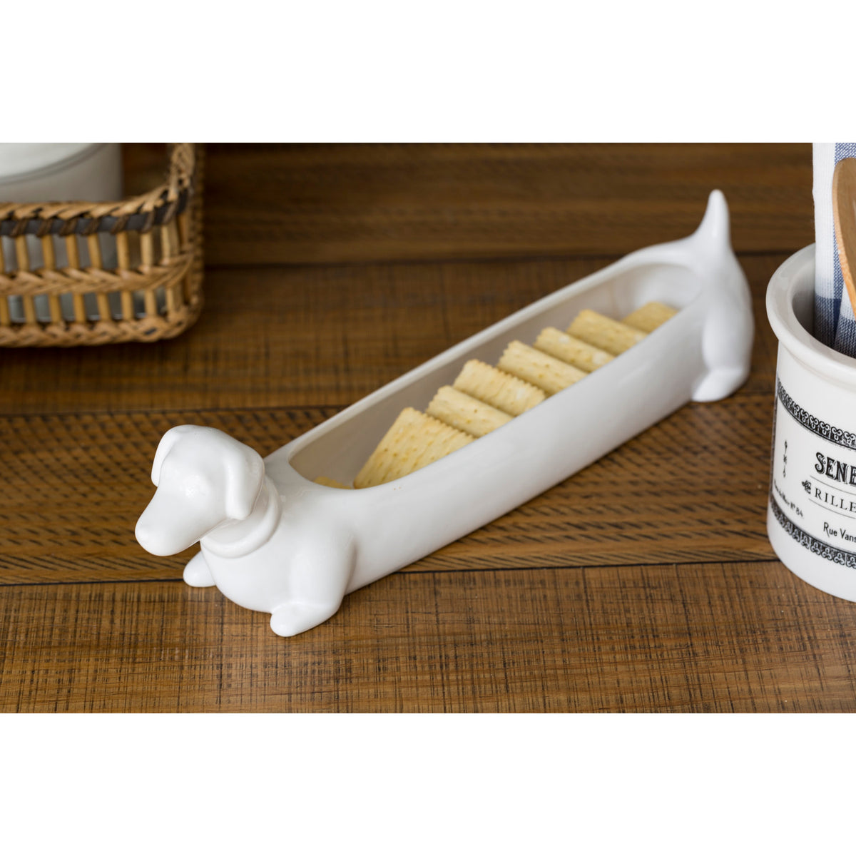White ceramic dachshund cracker dish filled with crackers