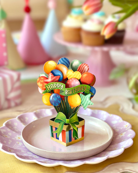 FreshCut Paper Mini Birthday Balloons 3D pop-up greeting card featuring colorful balloons, Happy Birthday banner, striped gift box, and coordinating notecard