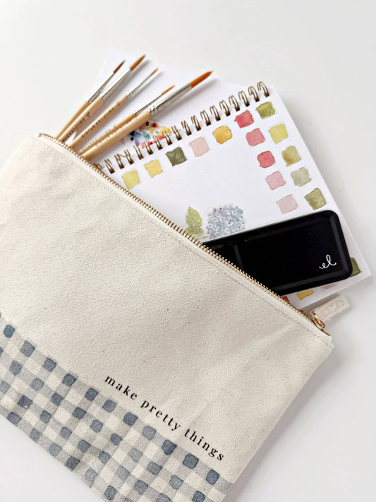Cream gingham canvas art supply pouch with watercolor paintbrushes