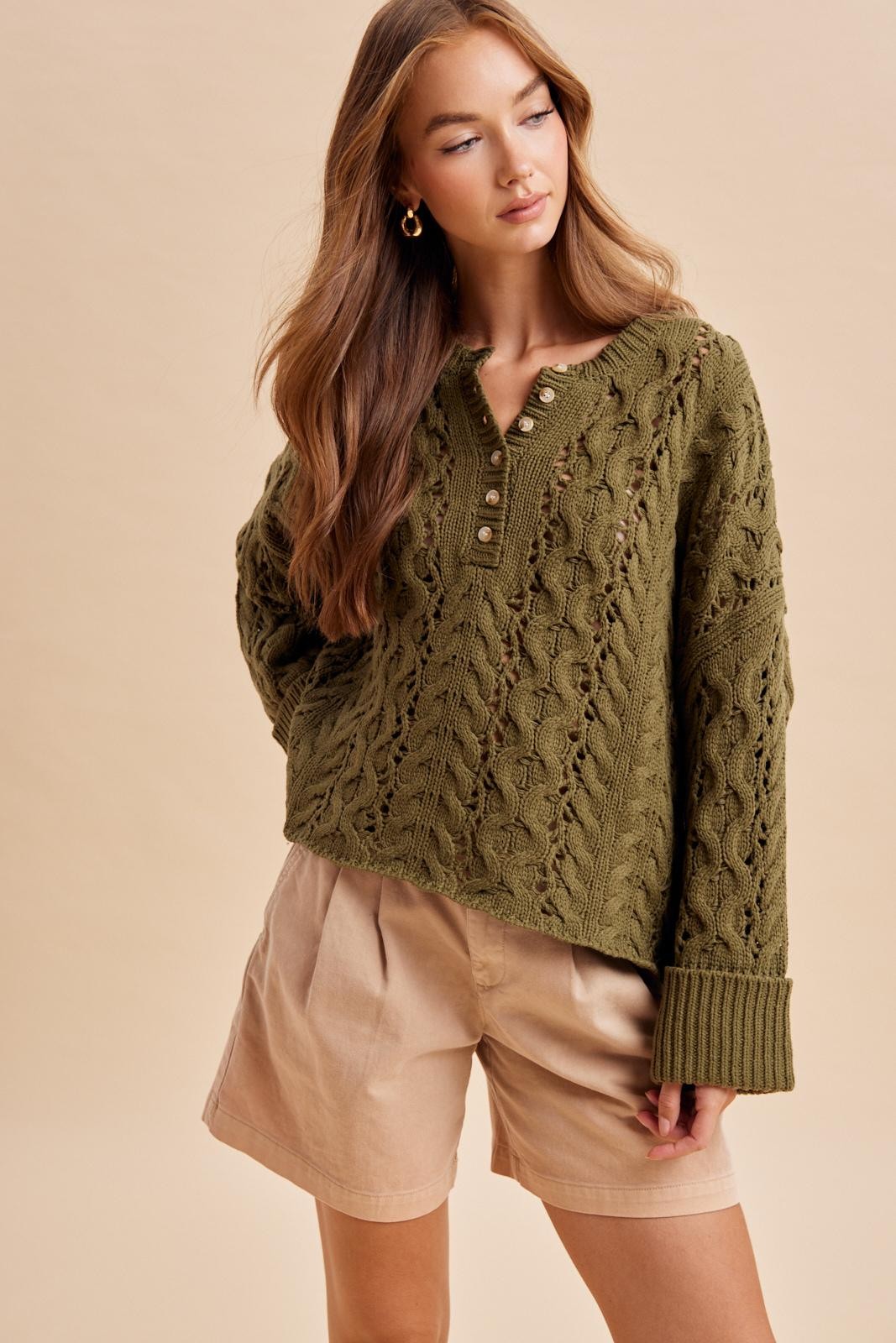 Olive cable knit Henley sweater for women styled with neutral shorts for fall