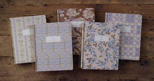 Five floral hardcover ESV journaling Bible volumes designed by Lulie Wallace
