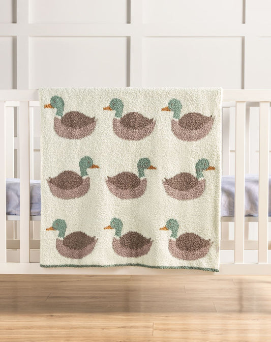 Mallard duck chenille baby blanket with sage green and brown ducks displayed on white crib in hunting nursery