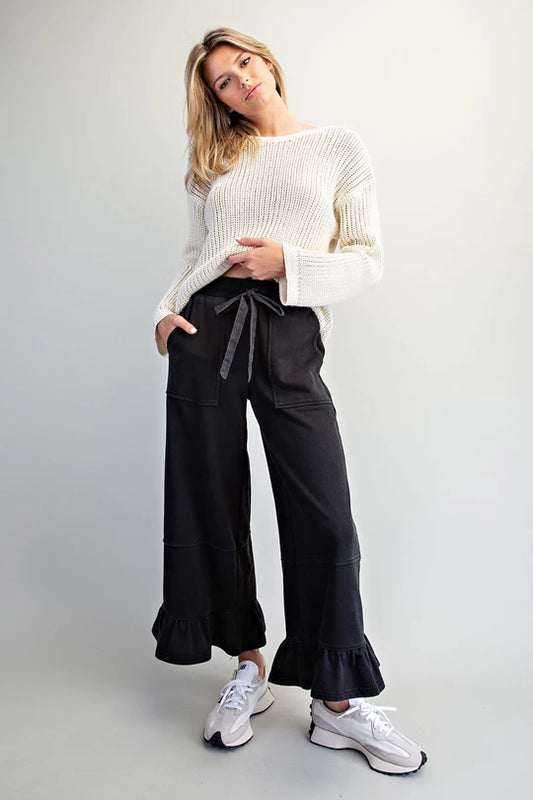 ee:some Collins ash black ruffle wide leg pants styled with cream sweater