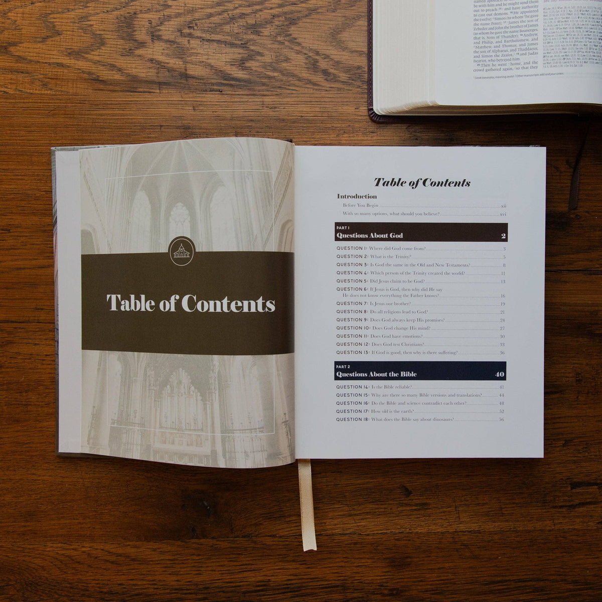 Use a unique description for each photo, such as an open copy of The Questions Handbook showing Scripture references and biblical answers to common Christian faith questions.