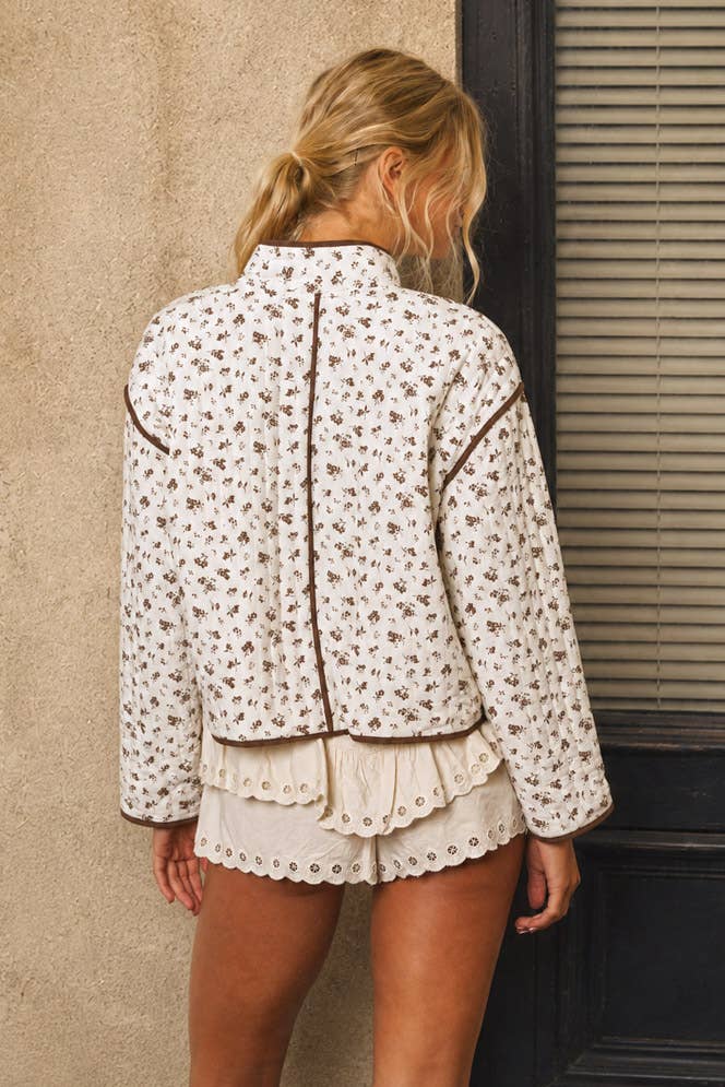 Back view of women’s ivory and brown floral boxy jacket