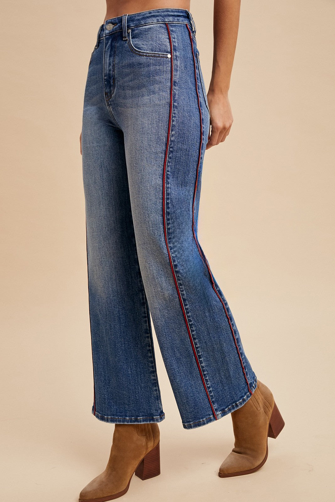 Women’s high rise medium wash wide leg jeans with double red side piping
