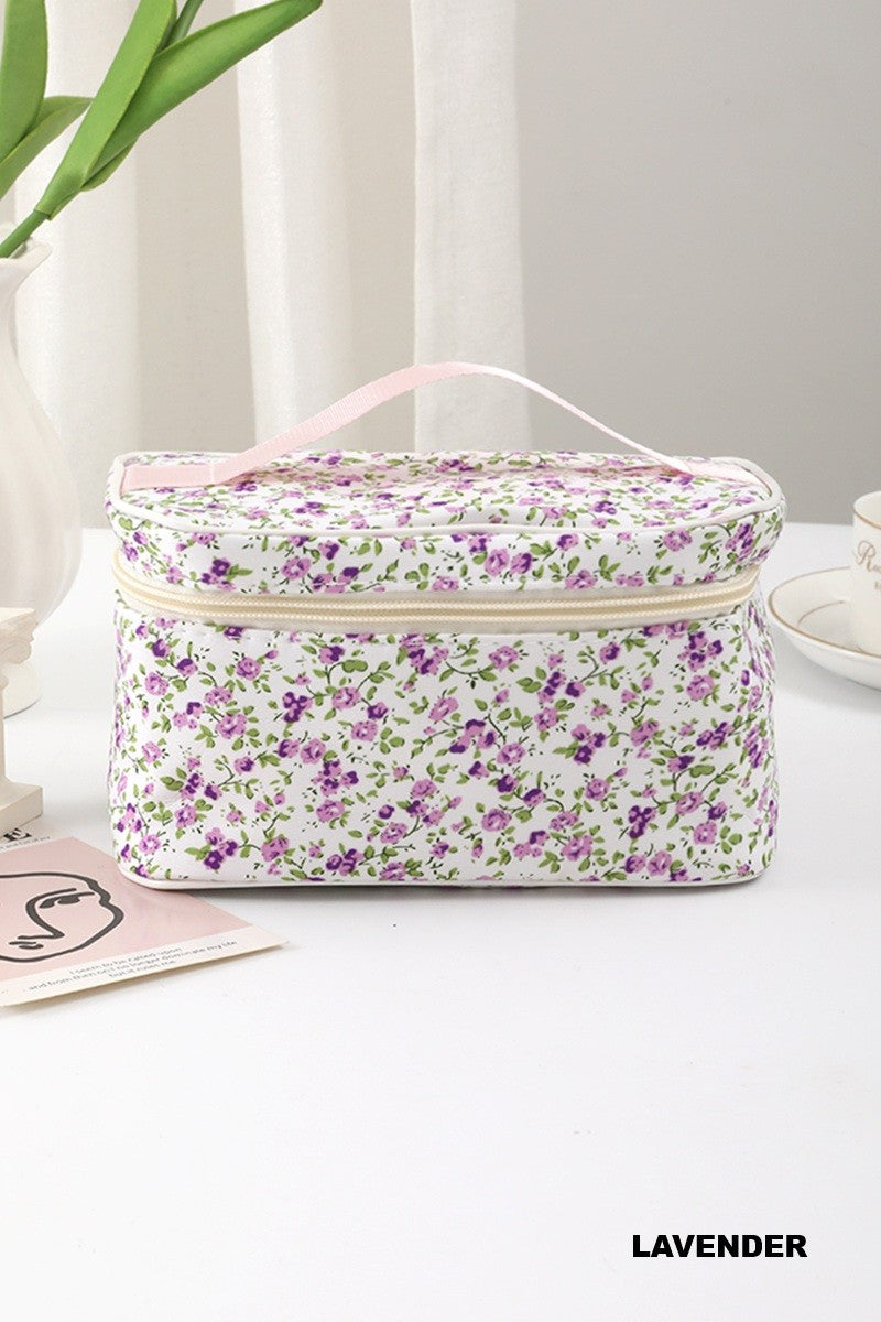 Garden Getaway quilted travel makeup bag with a lavender ditsy floral pattern, zipper closure, and carrying handle