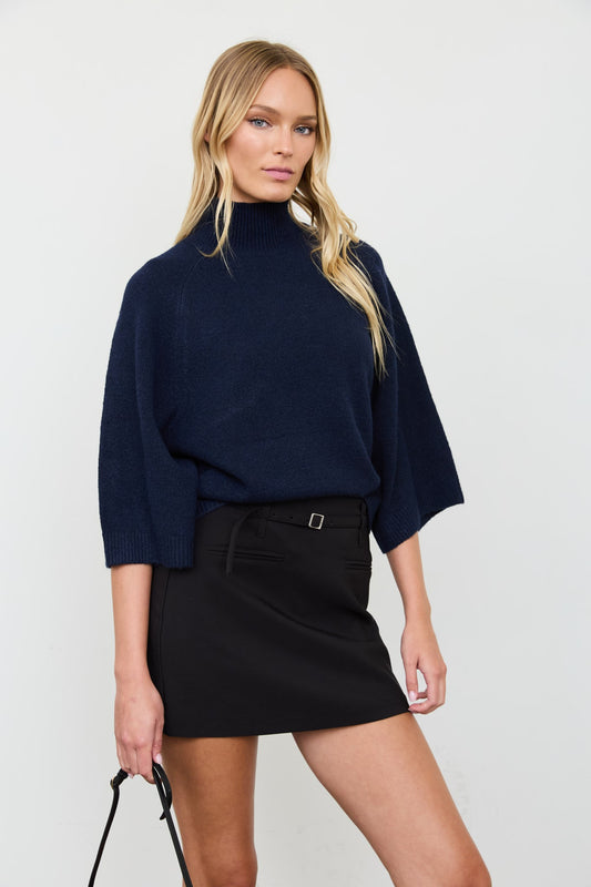 Side view of the Audrey navy boxy sweater with three-quarter-length sleeves