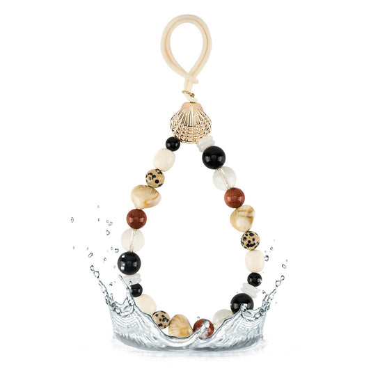 Neutral beaded bag charm with black cream brown and clear beads and gold shell accent