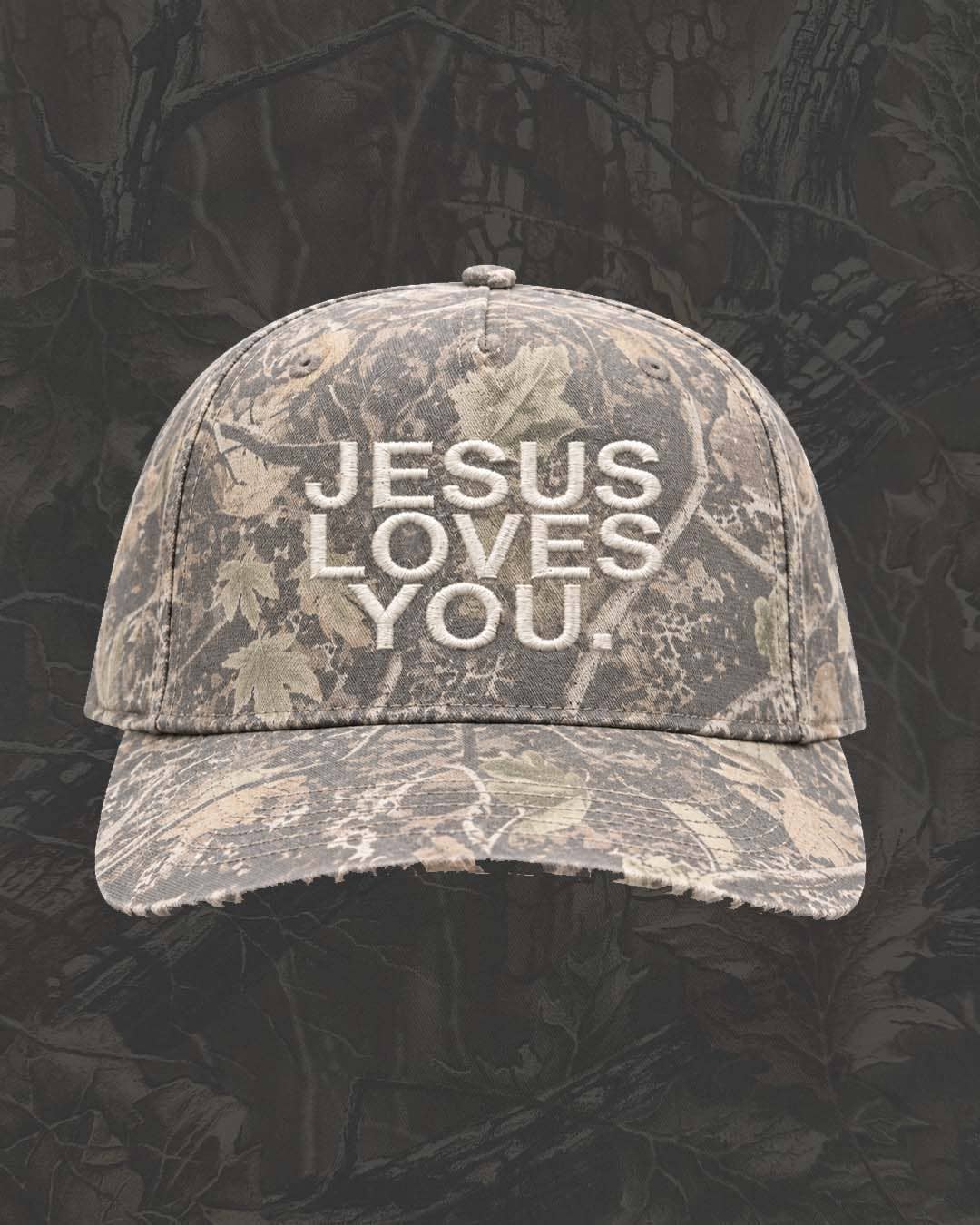 Jesus Loves You Christian camo hat with embroidered lettering, distressed bill and adjustable snapback