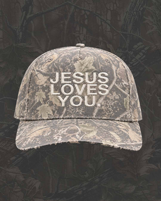 Jesus Loves You Christian camo hat with embroidered lettering, distressed bill and adjustable snapback