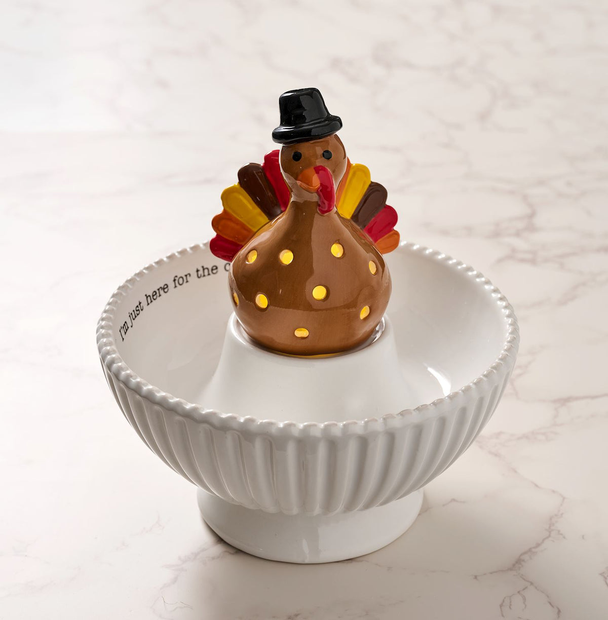 Mud Pie seasonal LED light-up sitters displayed with holiday serving dishes and decorative accessories