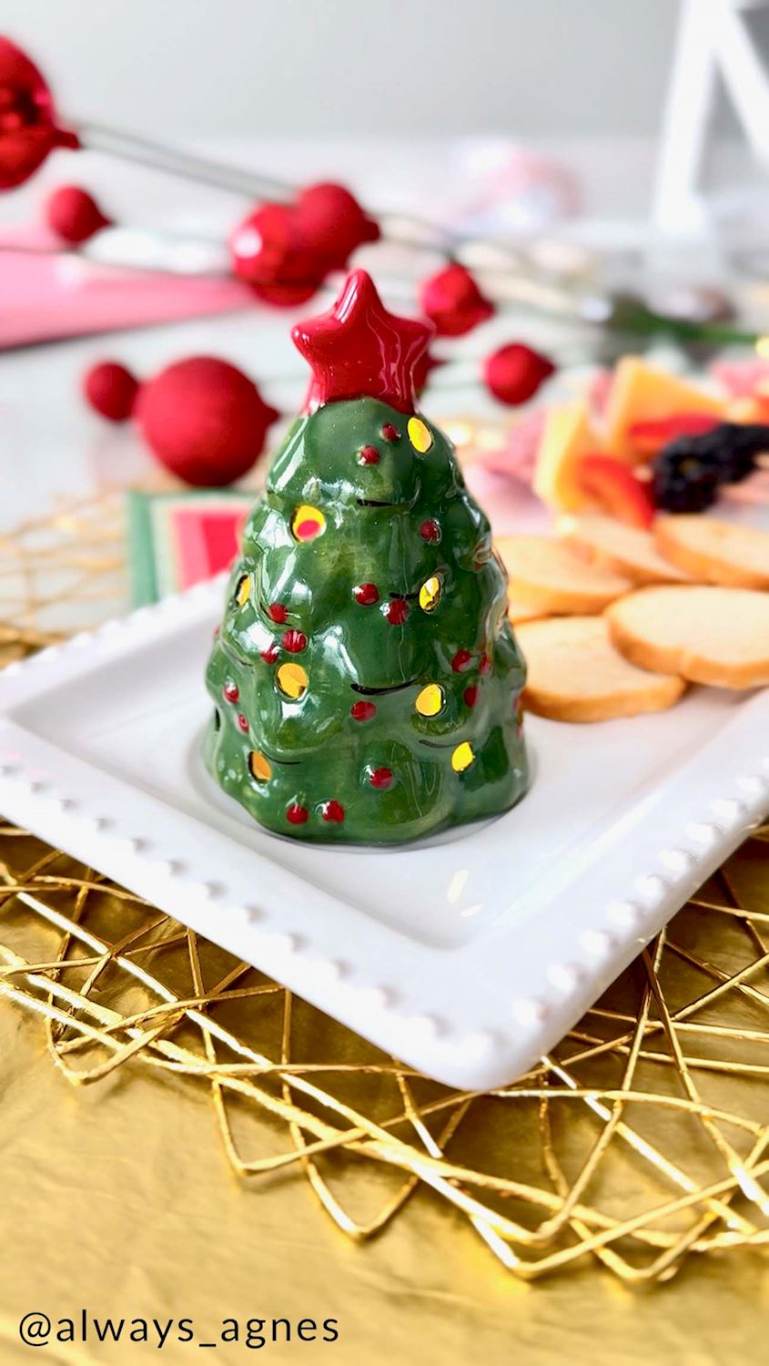 Mud Pie musical ceramic Christmas tree figurine glowing on a holiday serving tray