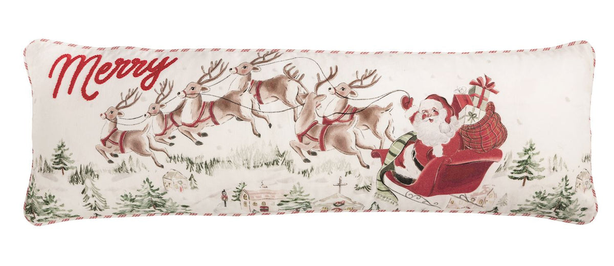 Mud Pie Santa Scene Long Christmas Pillow with embroidered Santa Claus, flying reindeer, snowy village illustration and striped piping.