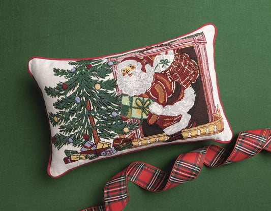 Mud Pie Santa Christmas tapestry throw pillow styled on a green background with festive red plaid ribbon