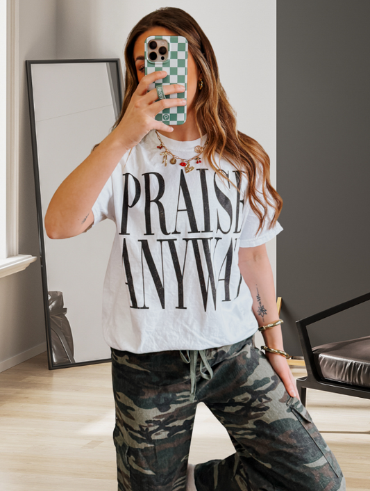 Woman wearing white Praise Anyway Christian Comfort Colors graphic tee with oversized black lettering