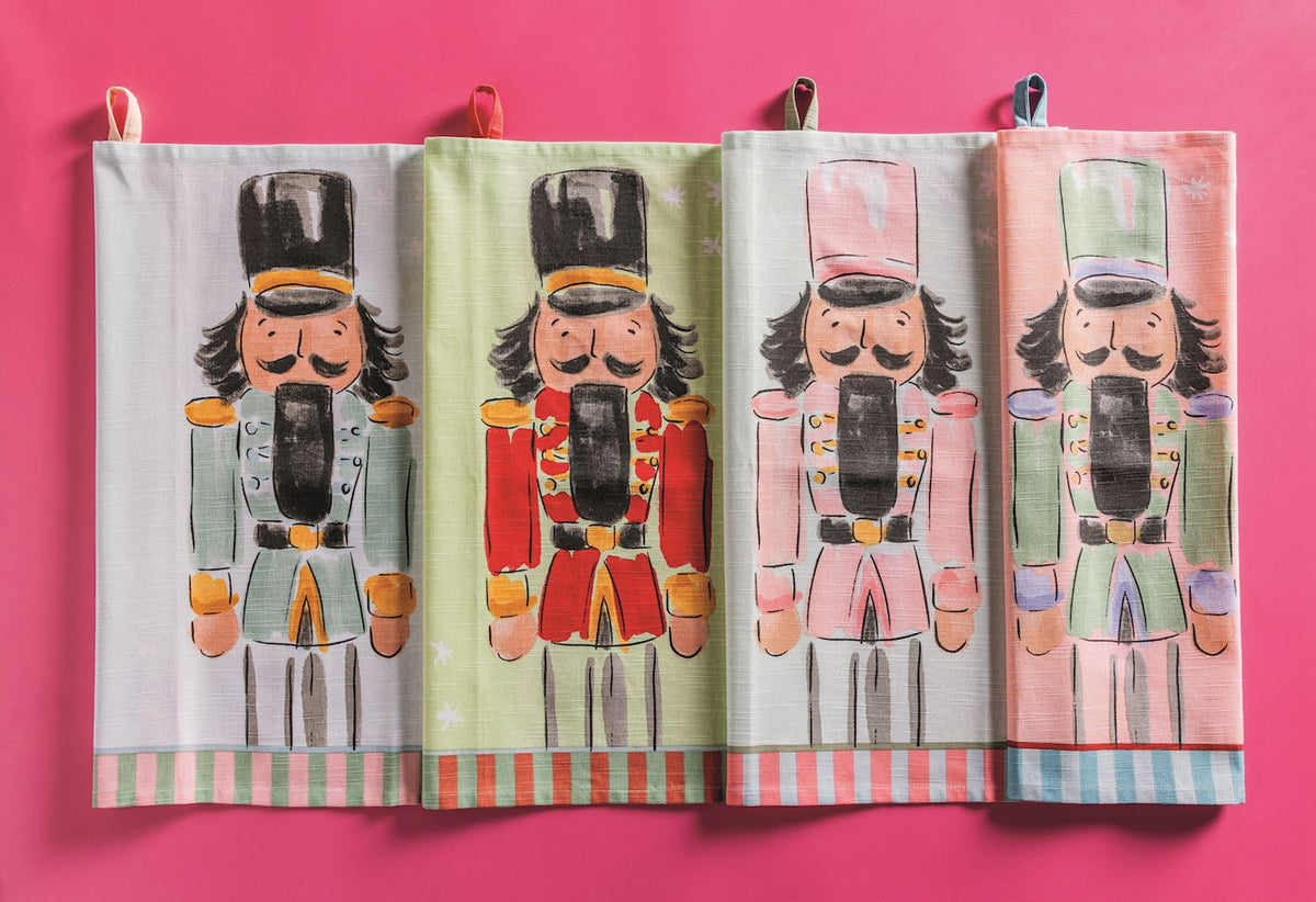 Four Mud Pie Nutcracker Christmas cotton hand towels in assorted pastel and traditional holiday colors