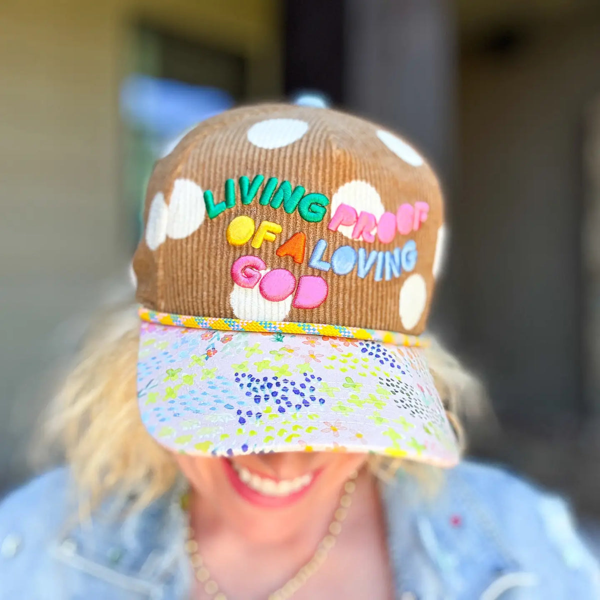 Women's Christian baseball cap with Living Proof of a Loving God embroidery, floral bill and polka dot corduroy