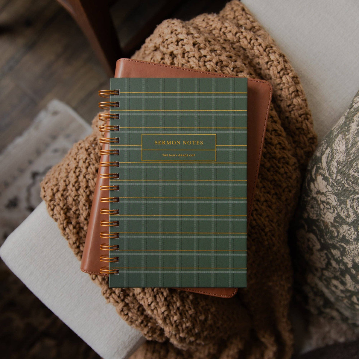 The Daily Grace Co Green Plaid Sermon Notes Journal with gold foil lettering, green linen cover, and gold spiral binding.