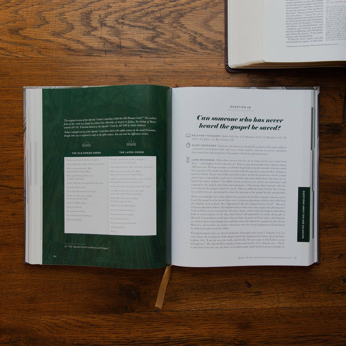 Use a unique description for each photo, such as an open copy of The Questions Handbook showing Scripture references and biblical answers to common Christian faith questions.