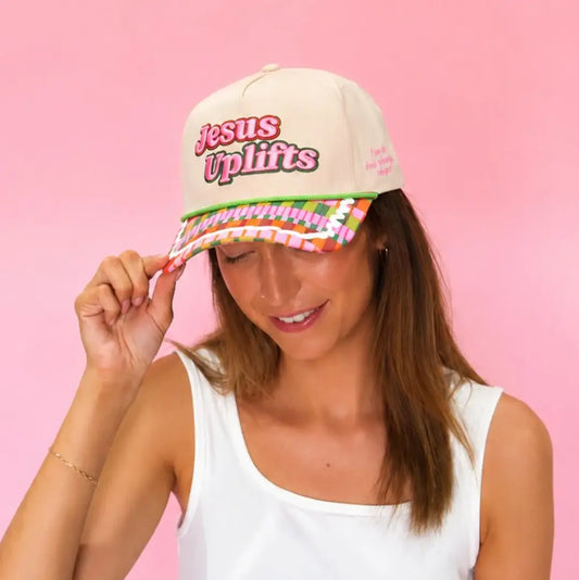 Jesus Uplifts Christian retro rope snapback baseball hat with cream crown, pink lettering, colorful patterned brim, and green rope accent