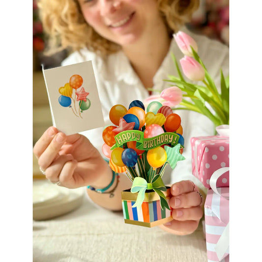 FreshCut Paper Mini Birthday Balloons 3D pop-up greeting card featuring colorful balloons, Happy Birthday banner, striped gift box, and coordinating notecard