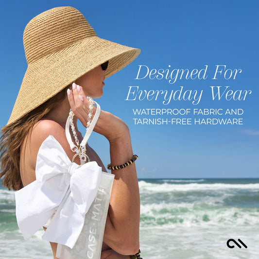Oversized white bow bag charm with gold-tone clip ring and waterproof fabric