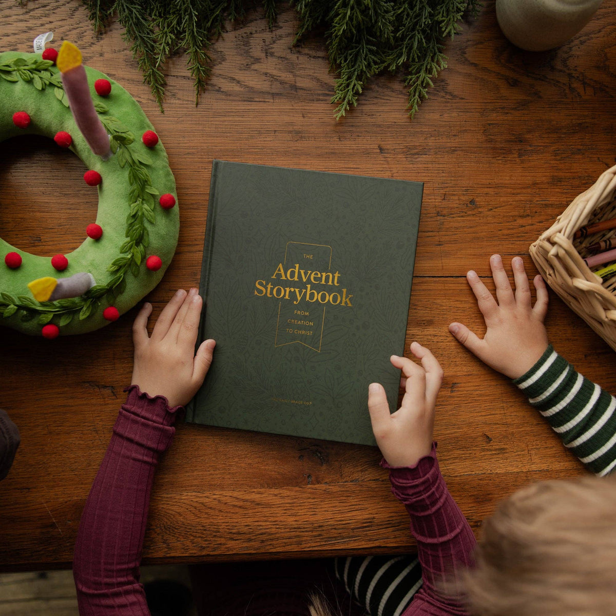 Children gathered around The Advent Storybook Christian family devotional, a hardcover Christmas Bible storybook for kids with Advent readings.