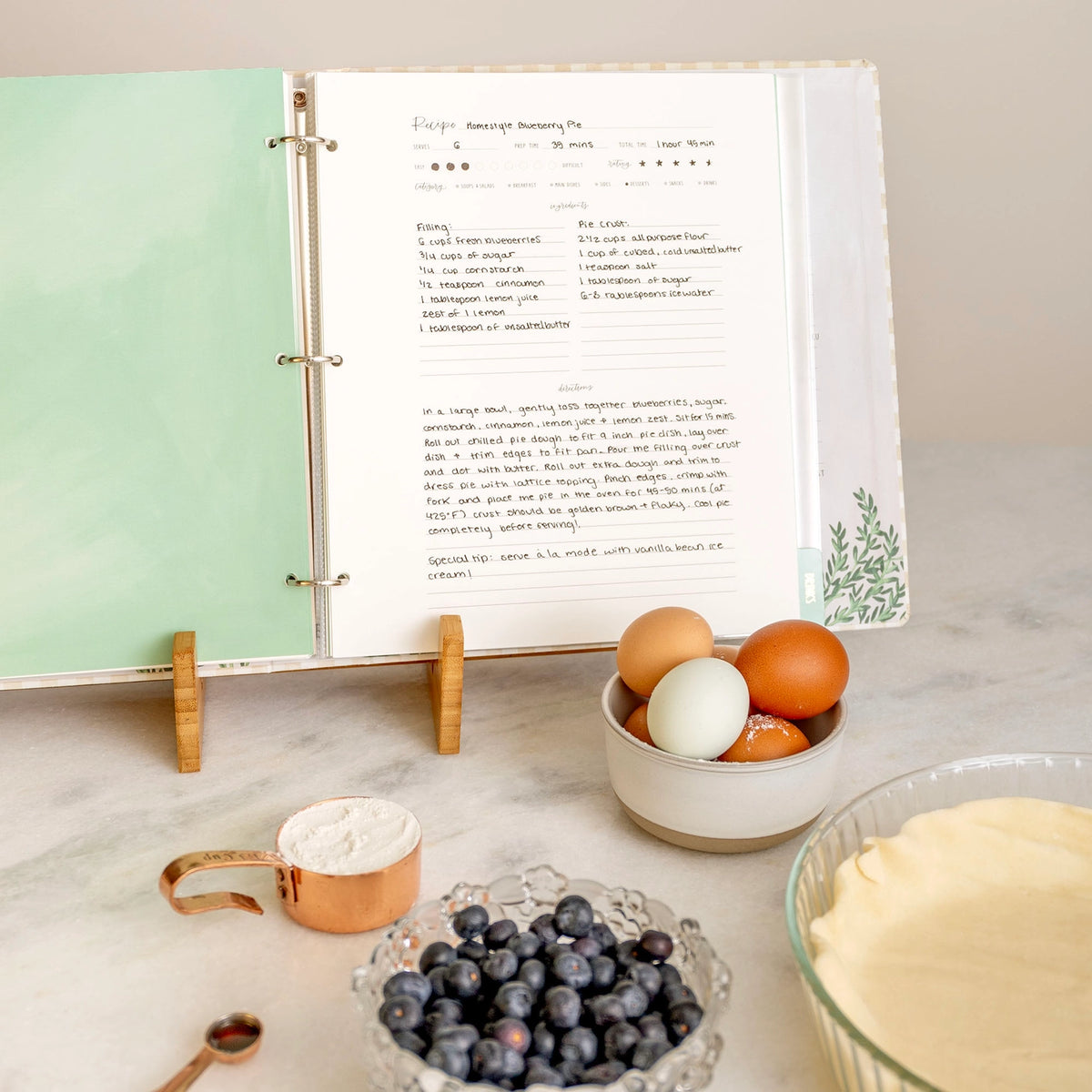 Large three-ring recipe binder with handwritten blueberry pie recipe page
