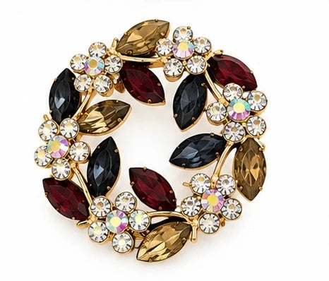 Winton + Waits Joyce floral wreath brooch featuring burgundy, black, and amber jeweled leaves with sparkling crystal flowers and gold-tone detailing.