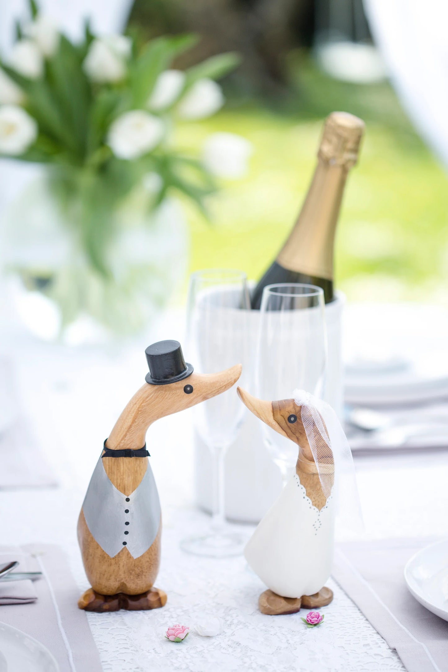 D.C.U.K. bride and groom wooden wedding ducks displayed on wedding table
