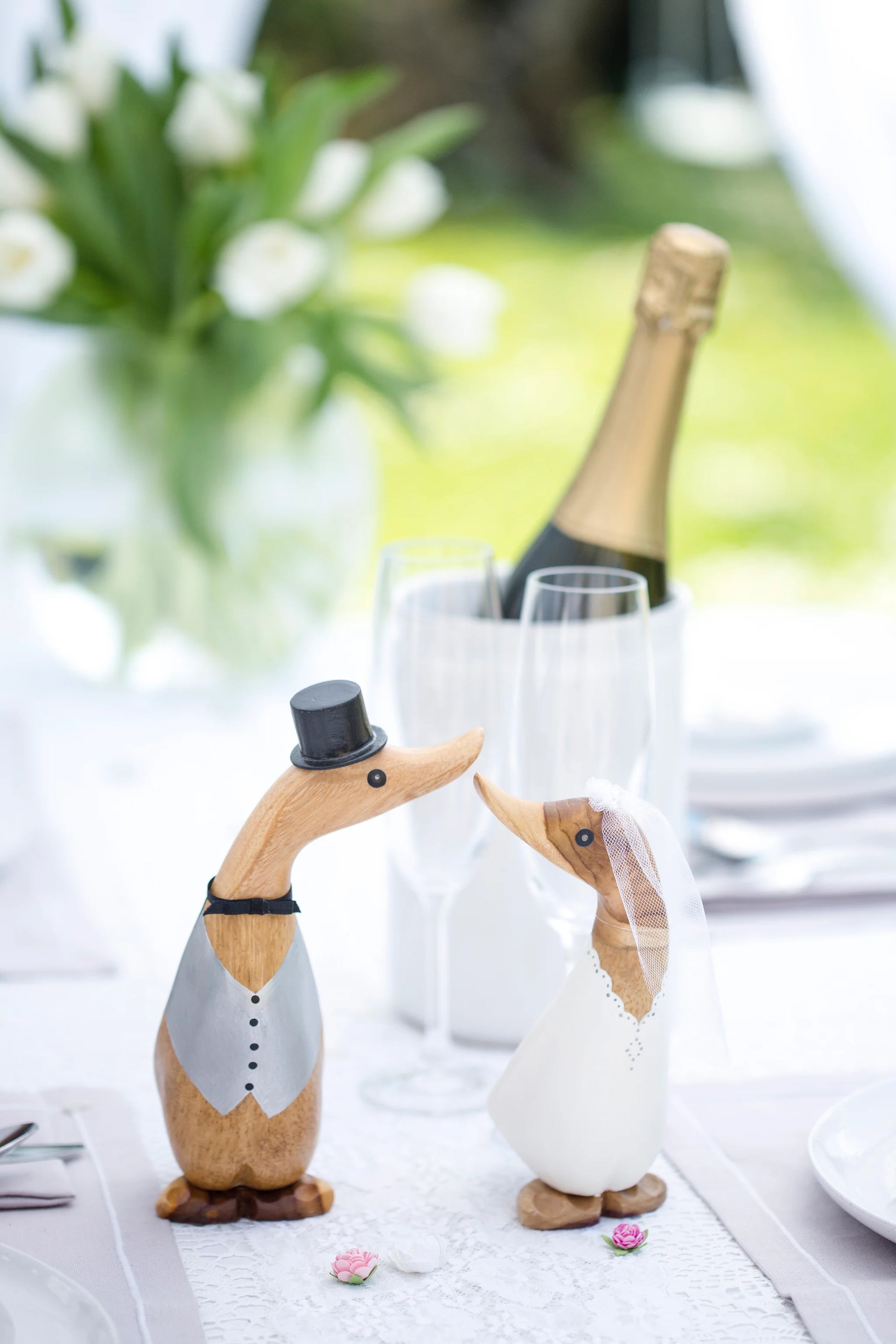 D.C.U.K. bride and groom wooden wedding ducks displayed on wedding table