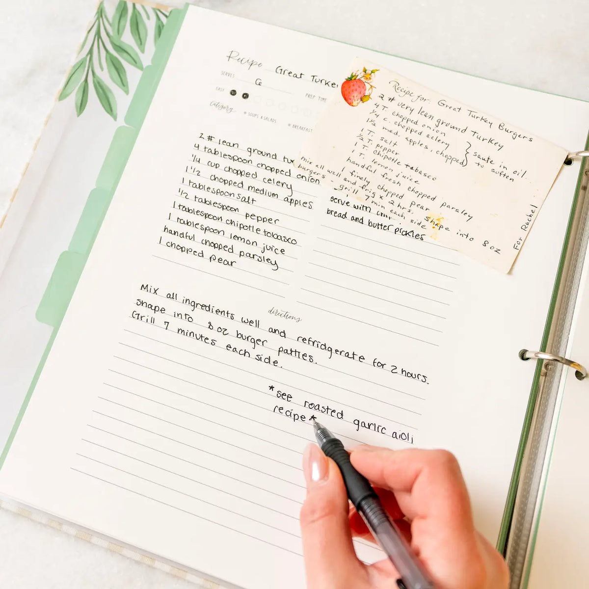 Large recipe binder with handwritten recipe pages and recipe card pocket