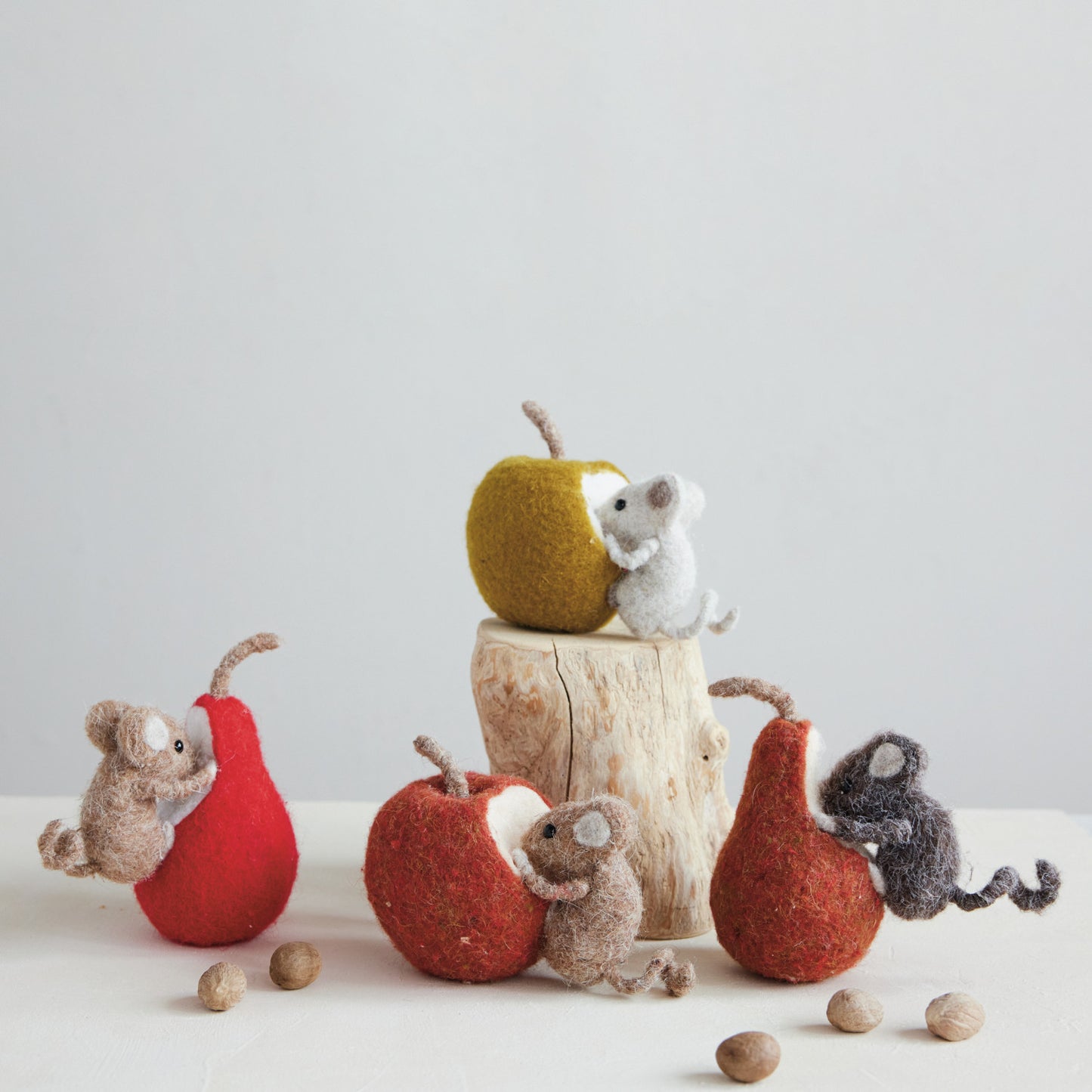 Four felted wool mouse figurines with red and orange pears and apples in assorted fall colors