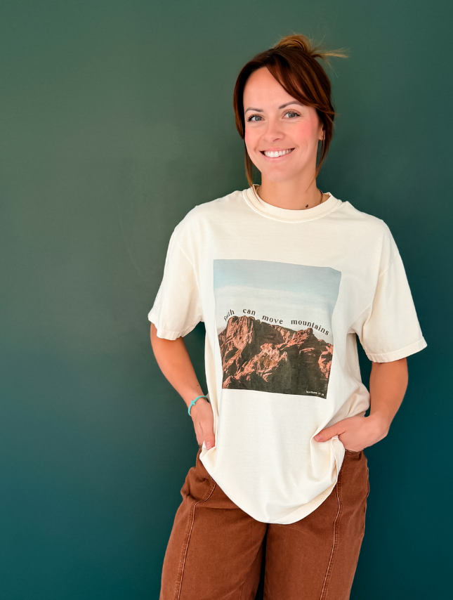 Woman wearing Faith Can Move Mountains Matthew 17:20 Christian graphic t-shirt