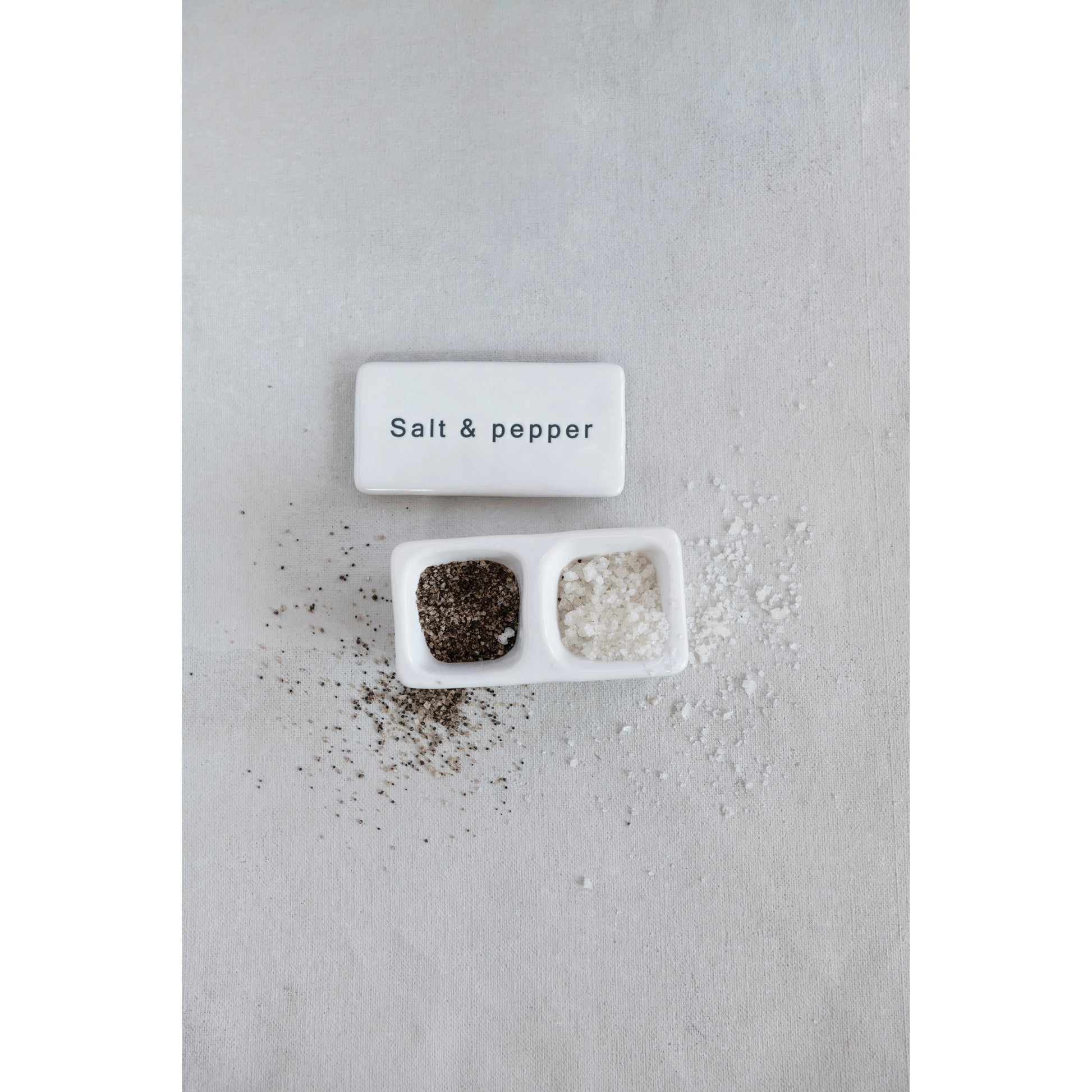 White stoneware salt and pepper pinch pot with lid and two compartments