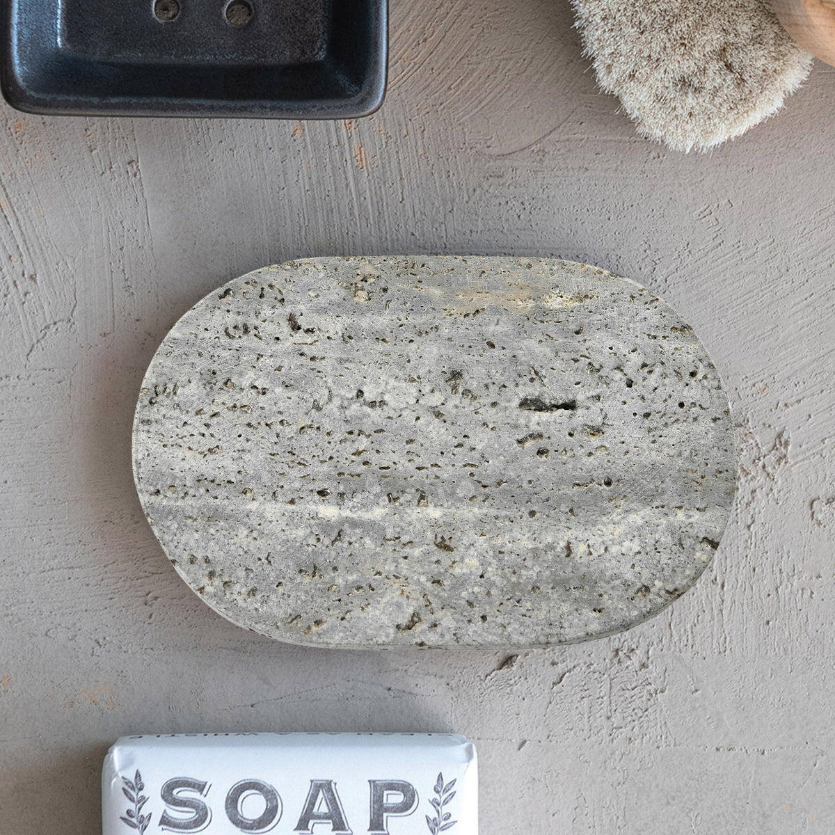 Grey oval natural travertine stone soap dish with unique veining
