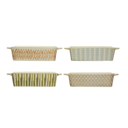 Four hand-stamped stoneware baking dishes in orange geometric, blue botanical, green stripe and brown medallion patterns

