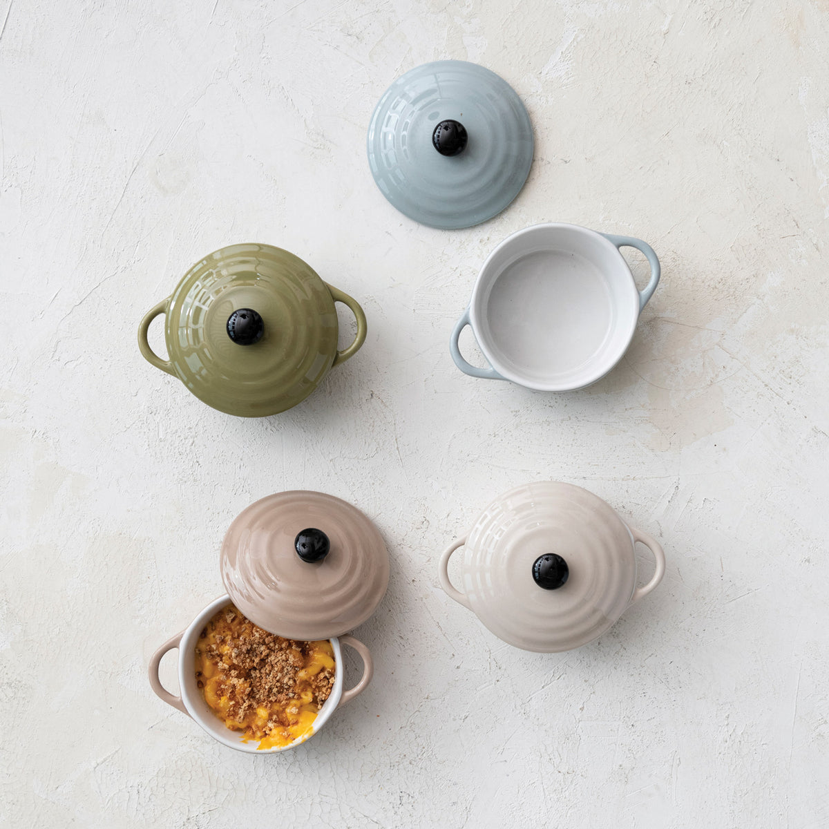 Stoneware mini cocottes with lids and side handles including open individual baking dish