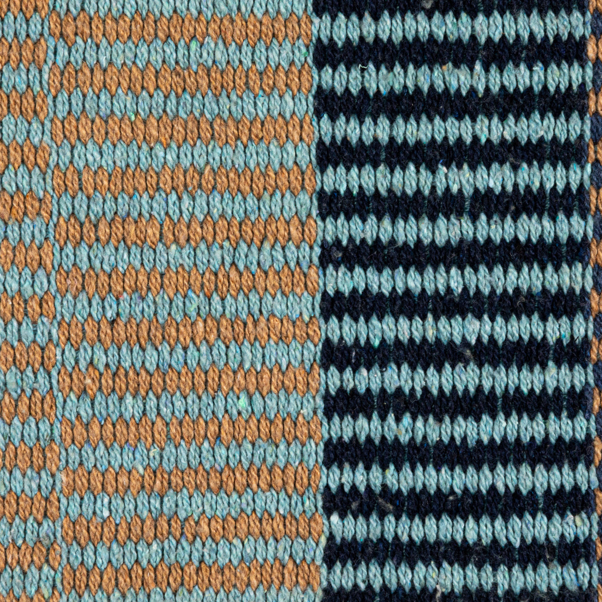 Close-up of Blue Ridge striped woven throw blanket with blue fringe and textured weave
