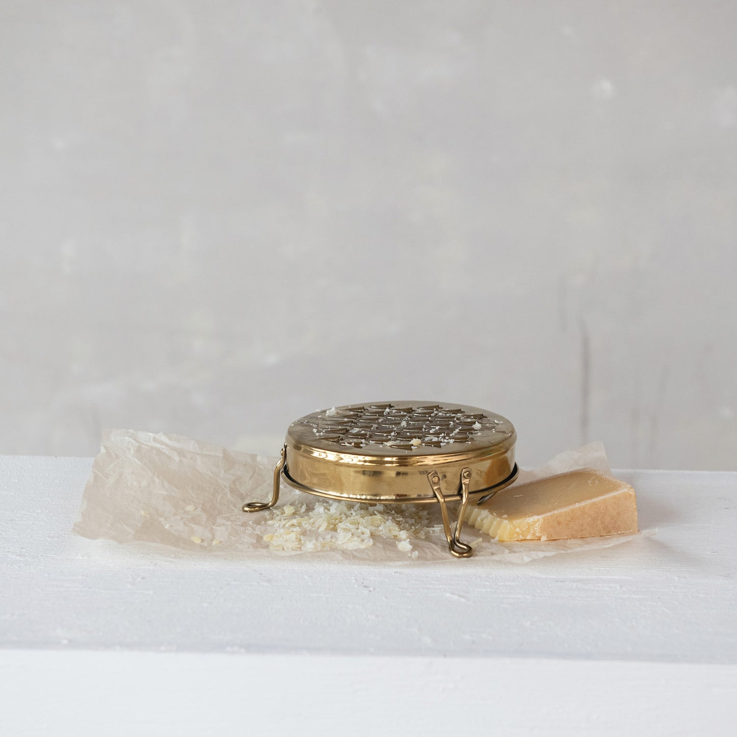 Marlow gold stainless steel footed cheese grater with round vintage-inspired design