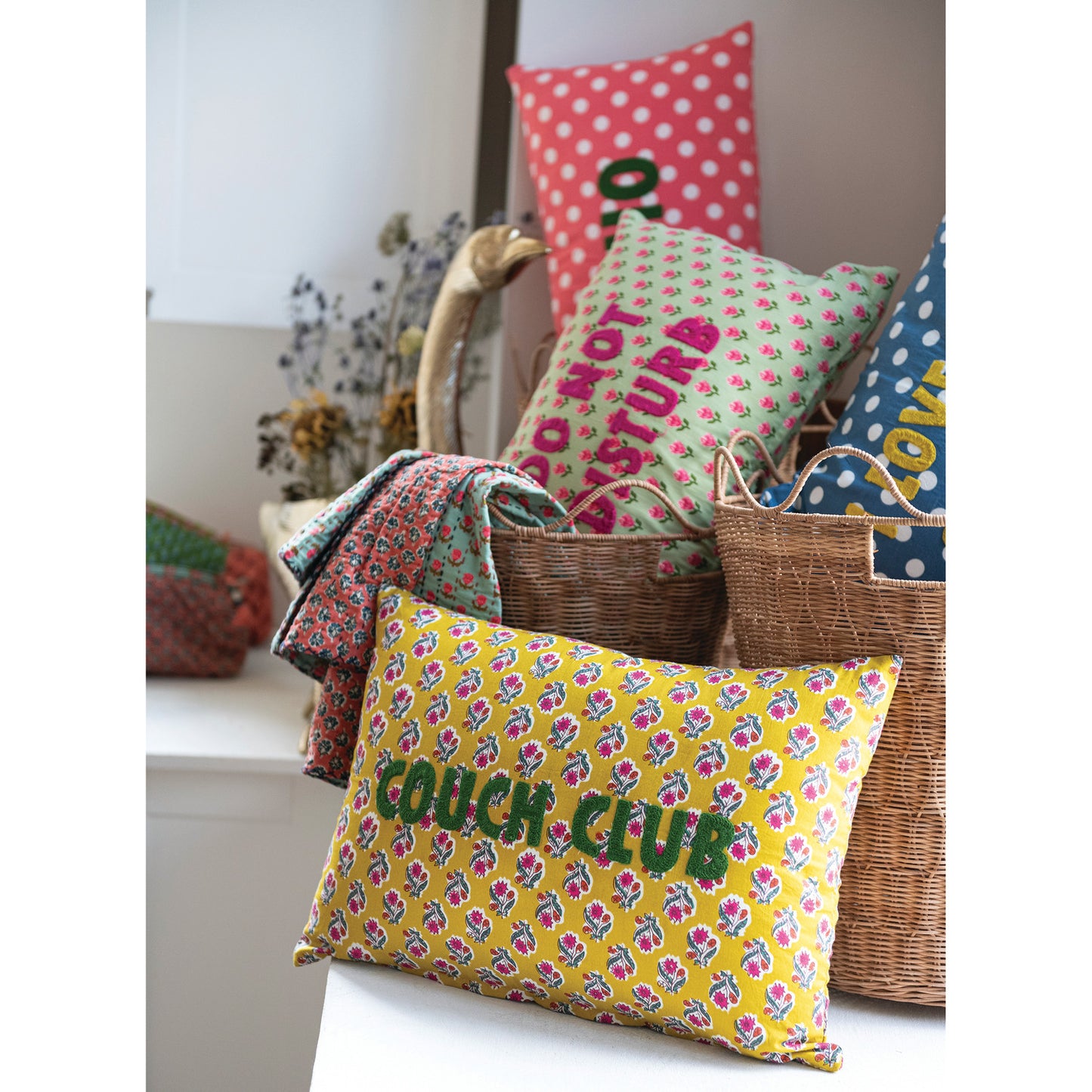 Couch Club floral lumbar pillow with mustard yellow cotton cover and green embroidered lettering