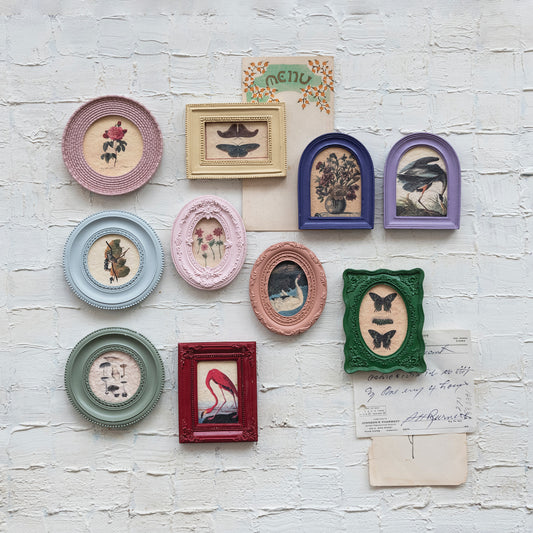 Colorful vintage mini framed art magnets arranged as a gallery wall