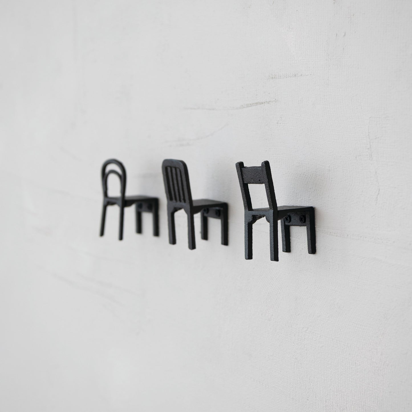 Black cast iron chair shaped wall hooks in Bentwood, Slat Back and Ladder Back styles